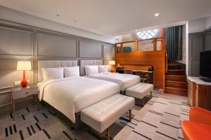 a bedroom with a bed and a desk and a television at London Marriott Hotel County Hall in London