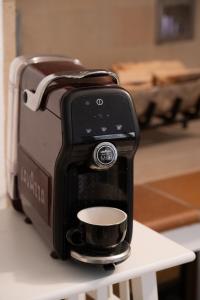 a coffee maker sitting on a table with a cup at Risi & Bisi - il nostro rifugio in Chioggia