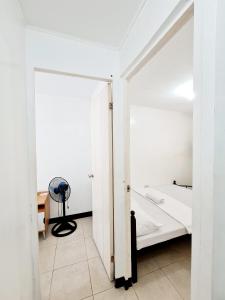 a white room with a bed and a desk at Calapan Transient House L12 in Calapan +34 photos