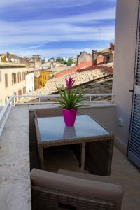 a table with a plant on top of a balcony at Il Piccolo Attico comfort house in Viterbo
