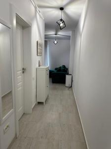 a hallway with a room with a couch and a door at Apartament Bonton Predeal in Predeal