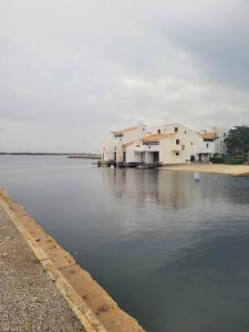 a large body of water with houses and buildings at Maison cosy Santa Barbara in Le Barcarès