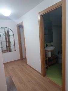 a bathroom with a mirror and a sink at O balcón das alvedosas in Islotes Erbedosas
