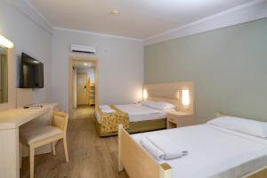 Postel nebo postele na pokoji v ubytování White Lilyum Hotel - All Inclusive