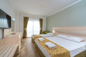 Postel nebo postele na pokoji v ubytování White Lilyum Hotel - All Inclusive