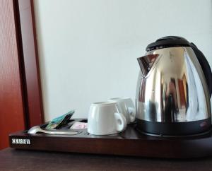 a coffee pot and two cups on a table at Willa Dorotka in Kudowa-Zdrój +13 photos