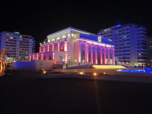 a building is lit up in pink and purple at Fabius 12 Caesars Resort & Spa in Iskele
