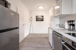 a kitchen with white walls and a counter top at Wasser in Ostseebad Koserow