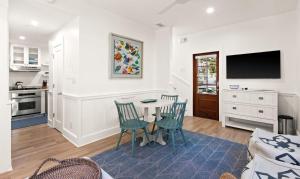 a kitchen and living room with a table and chairs at Just For Fun Carriage House in Santa Rosa Beach