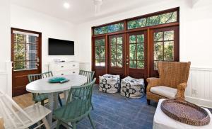 a living room with a table and chairs at Just For Fun Carriage House in Santa Rosa Beach
