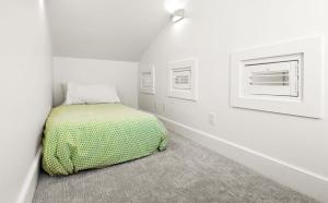 a bedroom with a bed in a white room at Just For Fun Carriage House in Santa Rosa Beach +30 photos