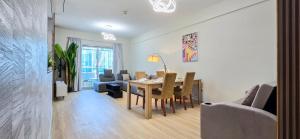a dining room and living room with a table and chairs at Marina View Spacious 2 BHK in Dubai