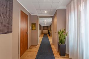 a corridor in an office building with a hallway at Hotel San Remo in Rome