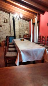 a dining room with a large table and chairs at La Canaleja in Cigüenza