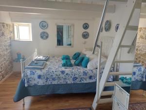 a bedroom with a bed with a ladder at Water Castle House in Kaštela