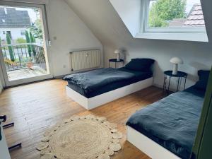 a bedroom with two beds and a large window at 3 Zimmer, 100 m2, Nähe Europa-Park in Hohberg