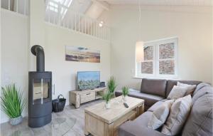 a living room with a couch and a fireplace at Gorgeous Home In Dagebüll With Wifi in Dagebüll +20 photos