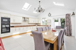 a kitchen and dining room with a wooden table and chairs at Celbridge House in Celbridge