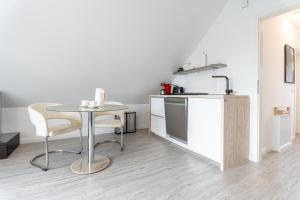 a small kitchen with a table and a counter at Wolken in Zinnowitz