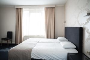 Postel nebo postele na pokoji v ubytování Hotel Essenza