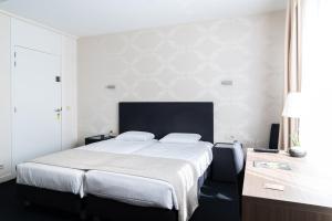 Postel nebo postele na pokoji v ubytování Hotel Essenza