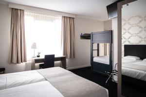 Postel nebo postele na pokoji v ubytování Hotel Essenza