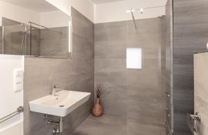 a white bathroom with a sink and a shower at Himmel in Zinnowitz