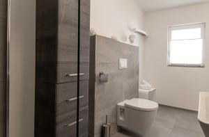 a bathroom with a toilet and a sink at Himmel in Zinnowitz +17 photos