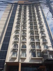 Un edificio alto con balcones a los lados. en Cityscape Hotel - Studio Unit, en Mandaue