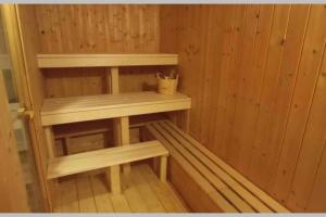 a inside of a sauna with wooden walls and shelves at Chachata Jeseniky sauna & jacuzzi in Dolní Moravice +29 photos