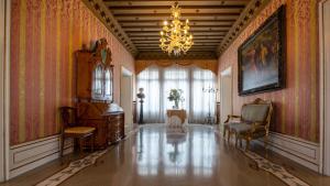 a living room with a chandelier and a table and chairs at Ca' Nigra Lagoon Resort Adults Only in Venice