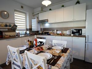 a kitchen with a table with plates of food on it at Relaxing Coresi Studio in Braşov