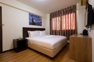 Ένα ή περισσότερα κρεβάτια σε δωμάτιο στο De Swift Hotel
