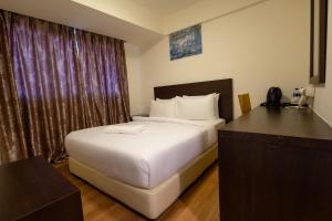 Ένα ή περισσότερα κρεβάτια σε δωμάτιο στο De Swift Hotel