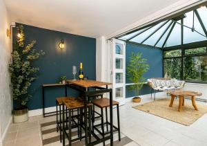 a living room with a table and chairs and a window at Stunning 3BD Oxfordshire Cottage in Enstone in Enstone