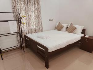 Postel nebo postele na pokoji v ubytování Palm Paradise Home Stay