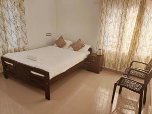 Postel nebo postele na pokoji v ubytování Palm Paradise Home Stay