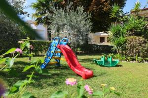 two slides in the grass in a yard at Asteras hotel in Hanioti +26 photos