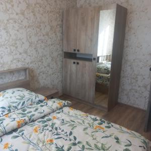 a bedroom with two beds and a mirror at Violet guest house in Dilijan +23 photos