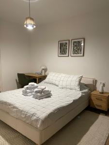 a bedroom with a bed with towels on it at Leafy Haven Hideout! in Timişoara +17 photos