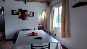 a dining room with a table with a hat on it at Cabaña Doña Alicia in San Rafael