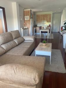 a living room with a couch and a table at Apartamento Cuchia in Cuchia