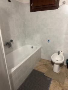 a bathroom with a white tub and a toilet at La Corte dei Celti in San Benedetto Del Querceto +63 photos