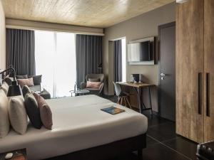 a hotel room with a bed and a living room at Number 11 St Julian's Malta - Handwritten Collection in St. Julianʼs
