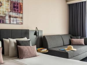 a living room with a couch and a table at Number 11 St Julian's Malta - Handwritten Collection in St. Julianʼs
