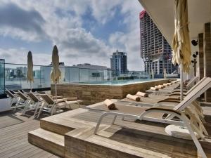 a row of chaise lounge chairs on the roof of a building at Number 11 St Julian's Malta - Handwritten Collection in St. Julianʼs