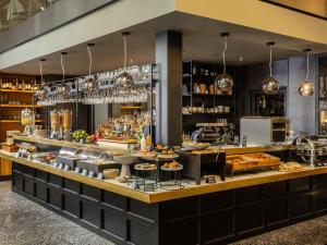 a restaurant with a counter with food on it at Number 11 St Julian's Malta - Handwritten Collection in St. Julianʼs