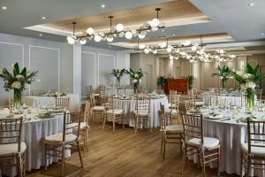 a banquet hall with white tables and chairs at Faro Blanco Resort & Yacht Club Marathon, Curio by Hilton in Marathon +61 photos