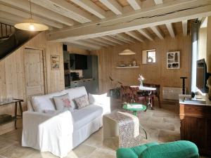 a living room with a white couch and a table at Casa Pertica in Ceton