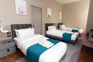 Postel nebo postele na pokoji v ubytování Hotel Royal